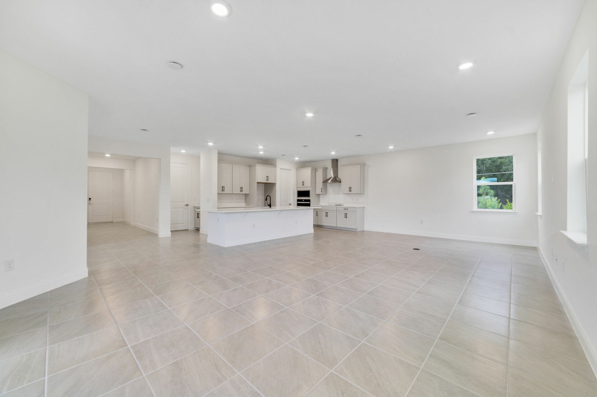 great room with views of kitchen and access to sliding glass door