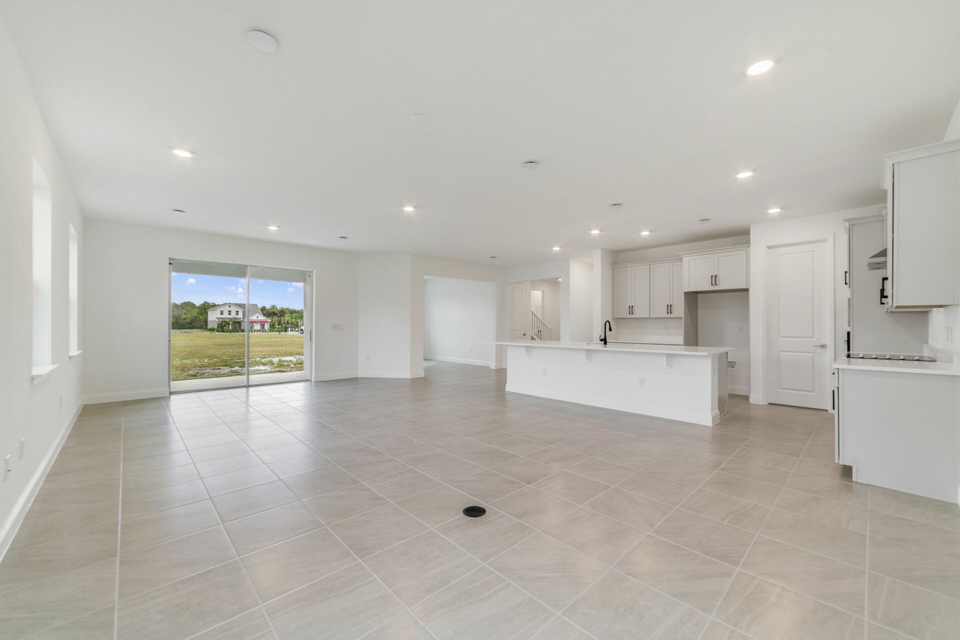 great room with views of kitchen and access to sliding glass door