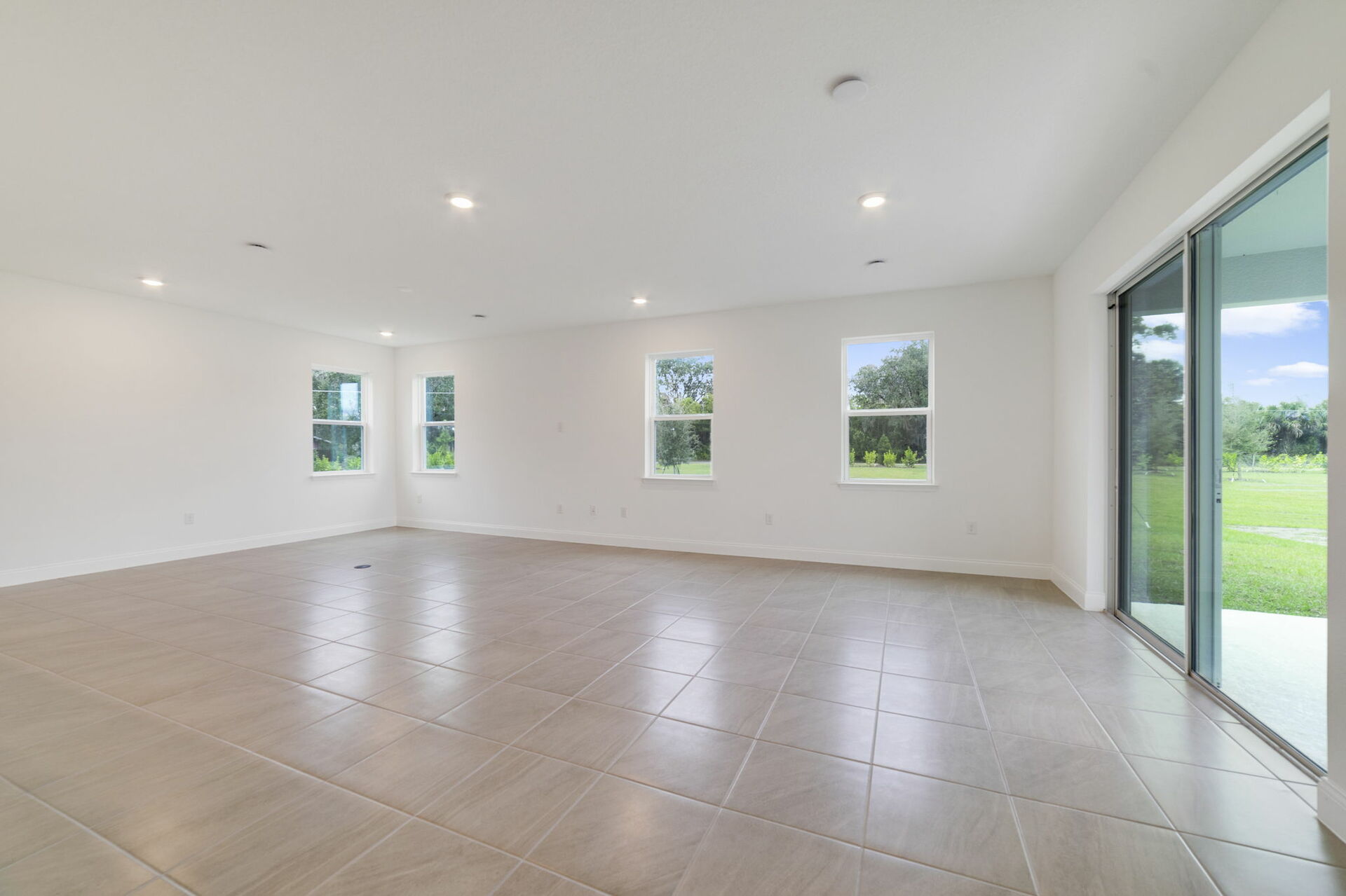 great room with views of kitchen and access to sliding glass door