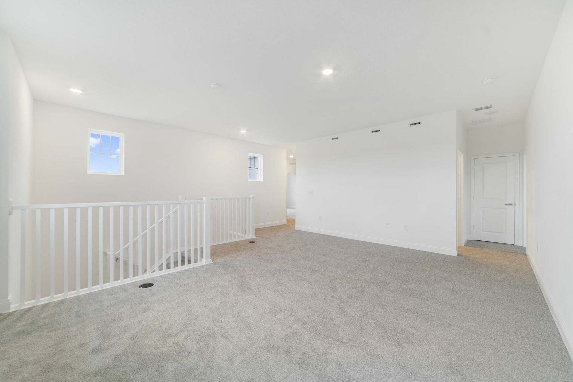 loft with carpet and access to the stairs