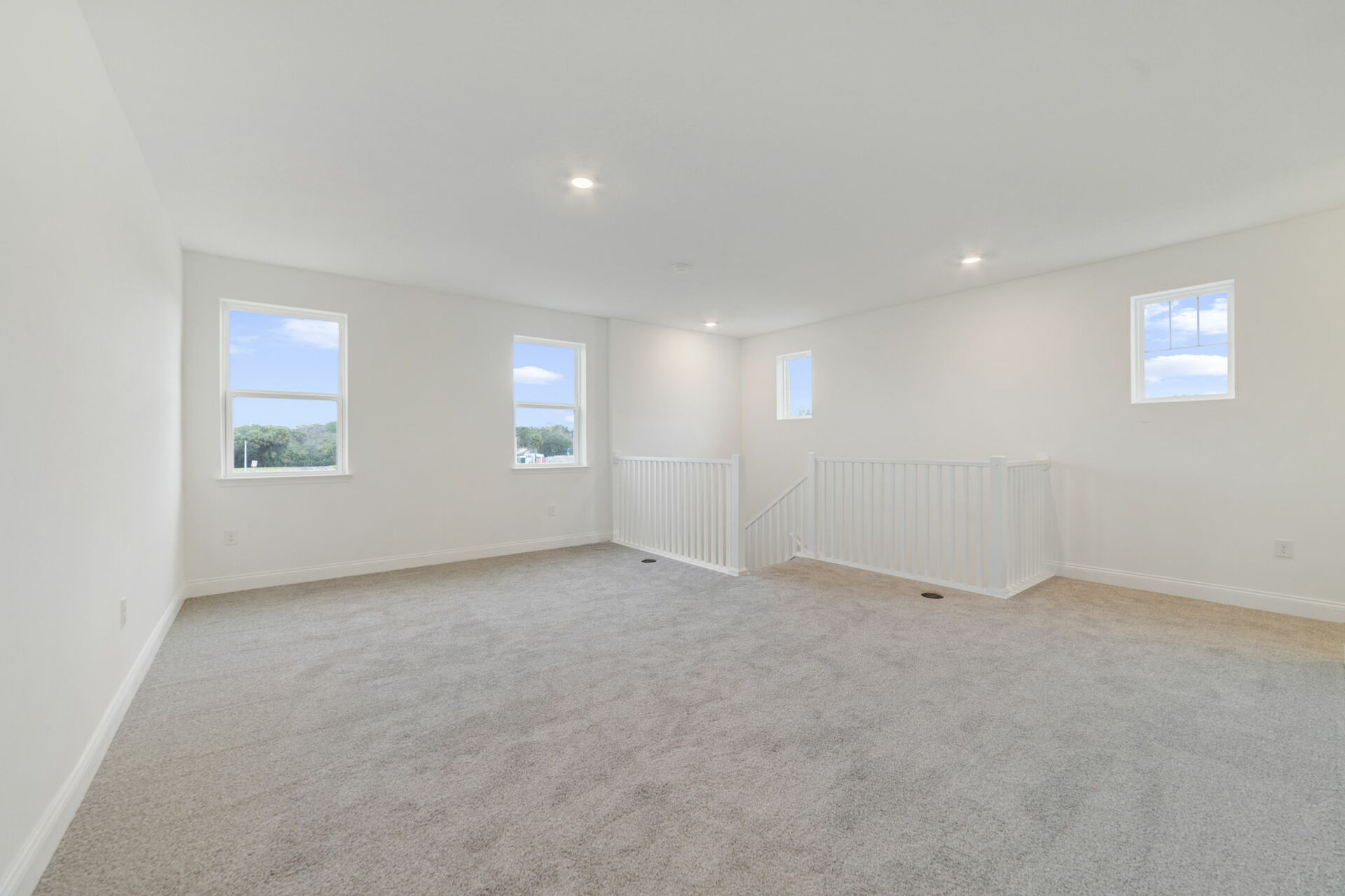 loft with carpet and access to the stairs