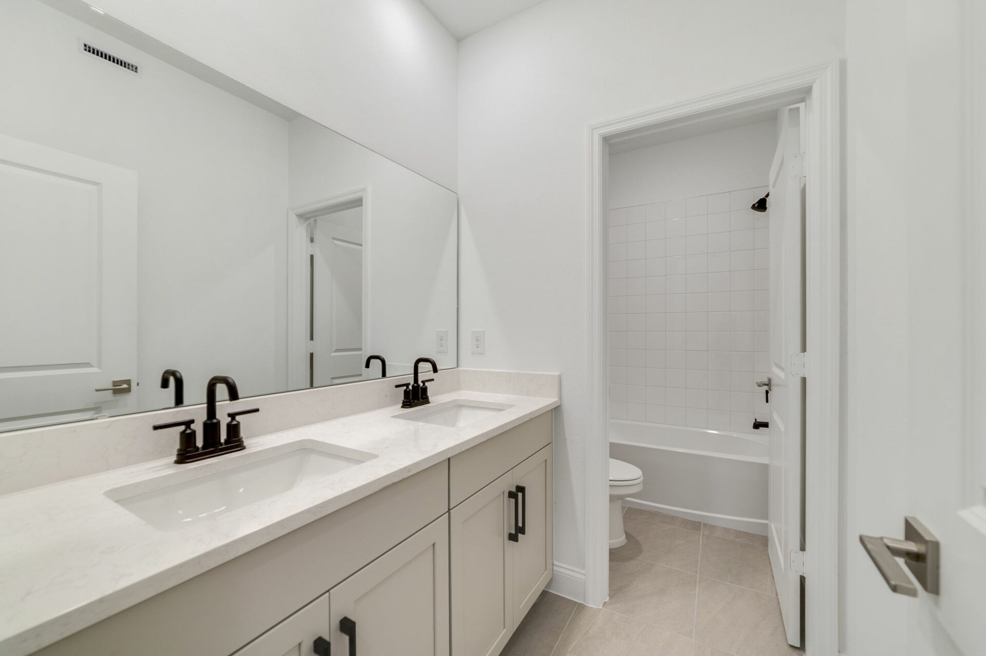 dual sink vanity with water closet and shower