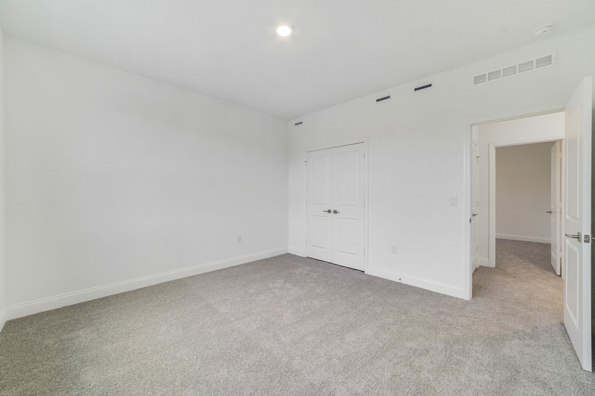 secondary bedroom with carpet and access to closet