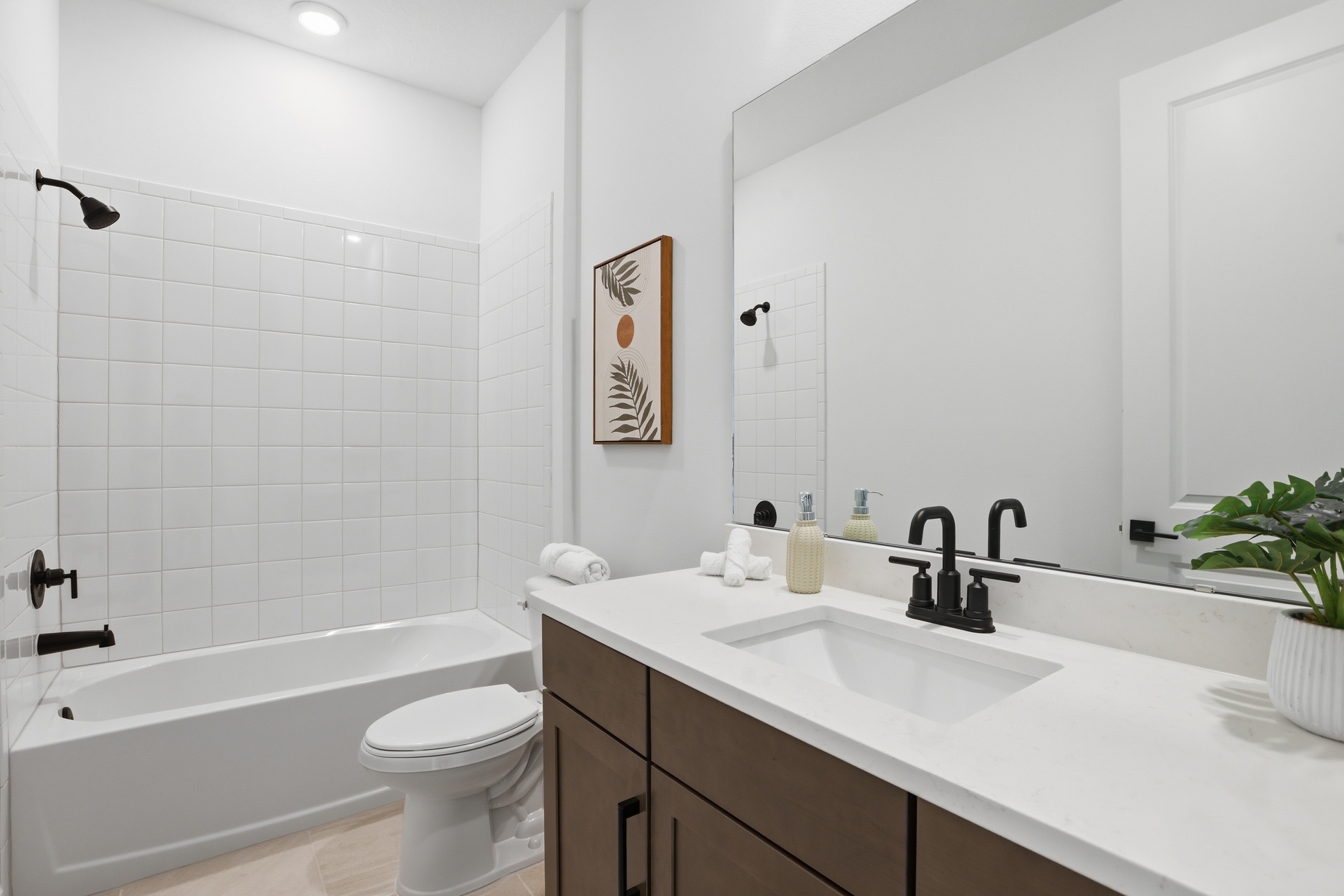 guest bathroom with single sink vanity, water closet and shower