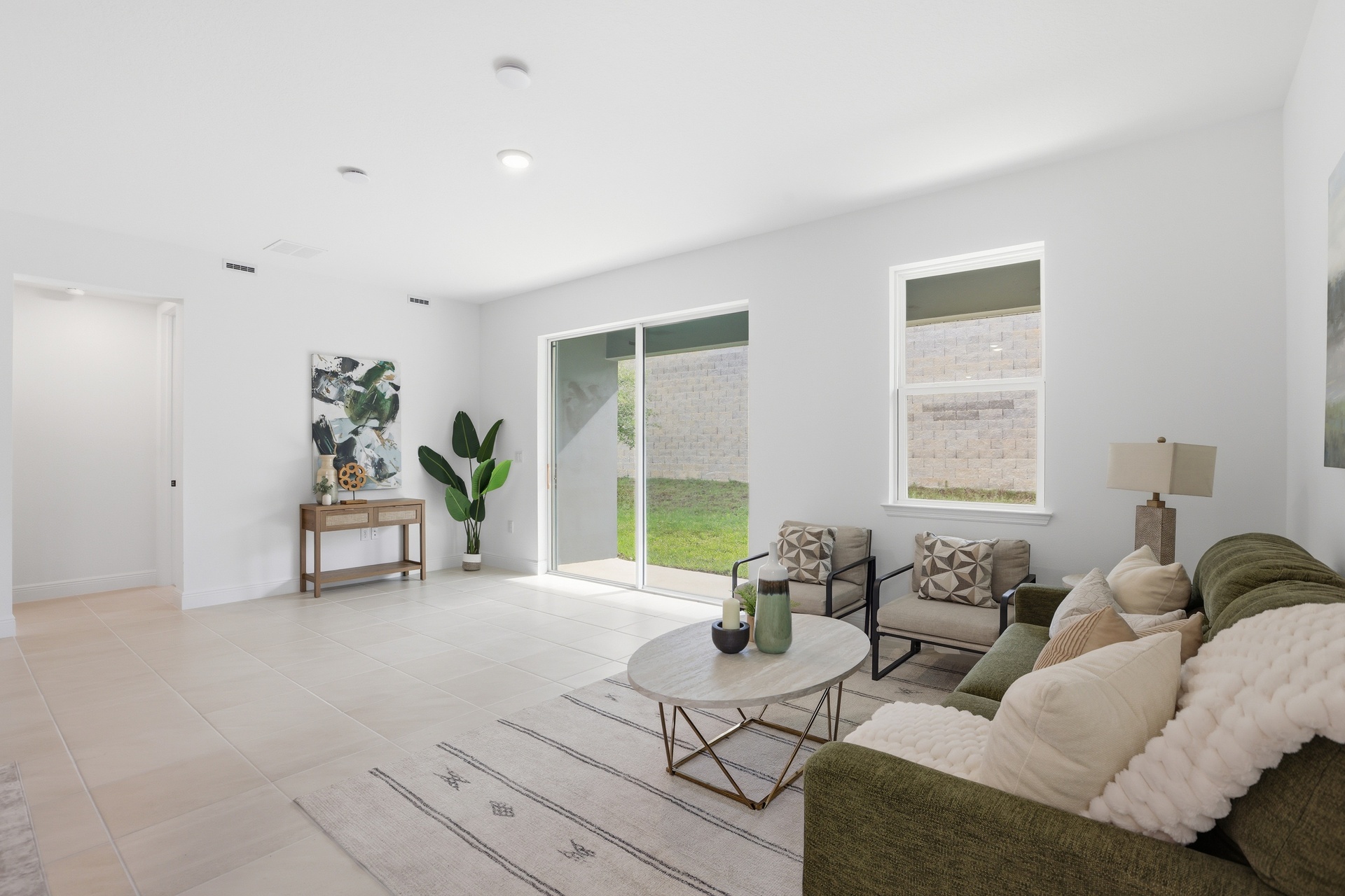room with access to the covered lanai and view of the kitchen.