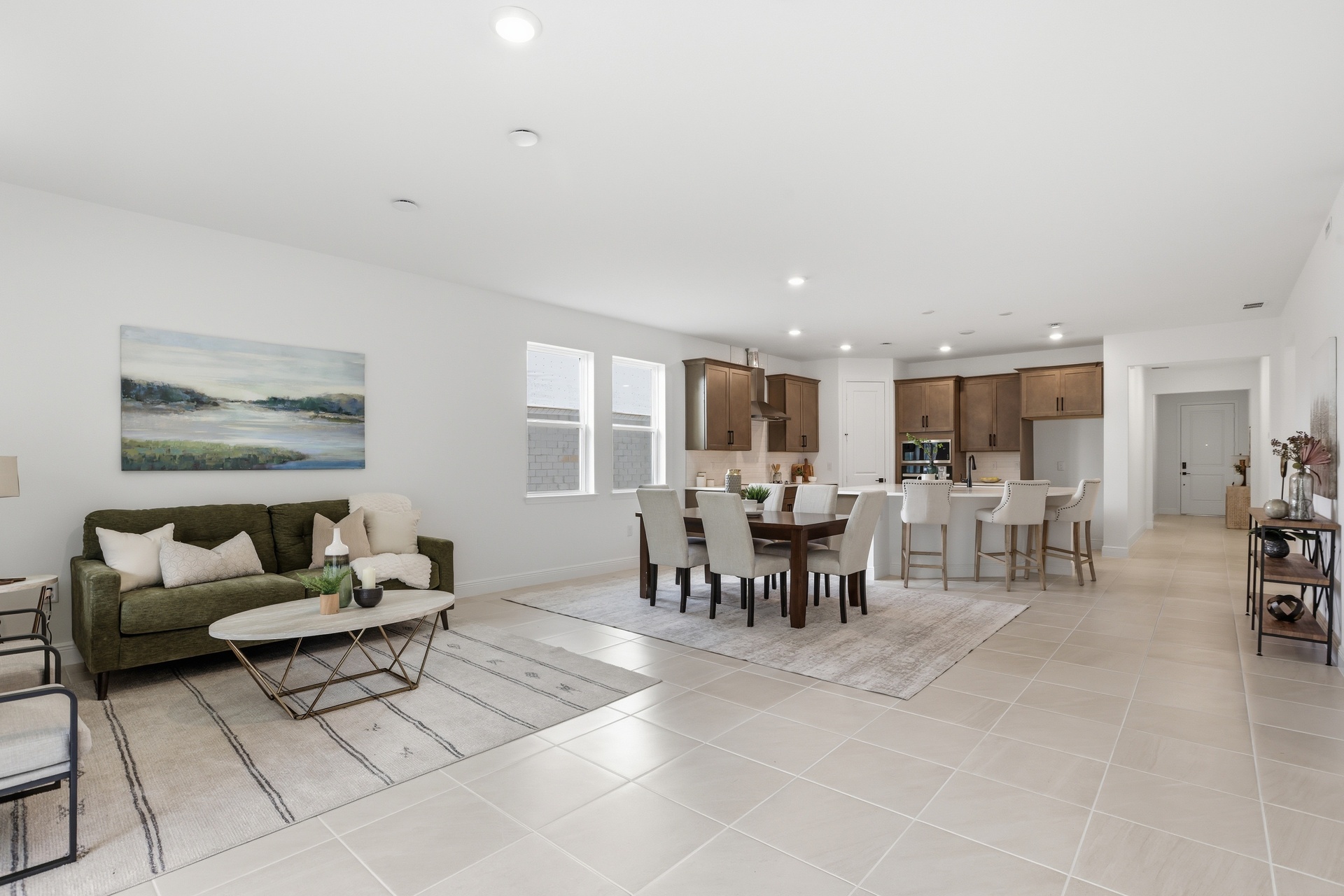 room with access to the covered lanai and view of the kitchen.