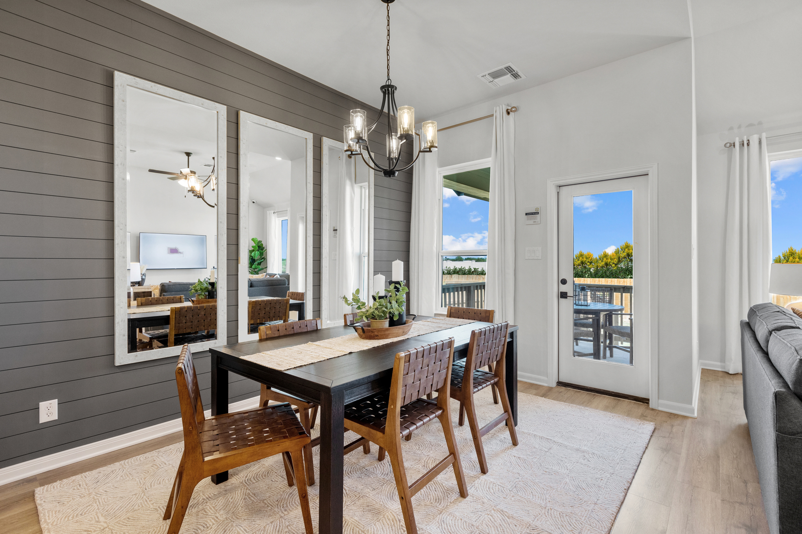 dining room with rug, brown table & chairs