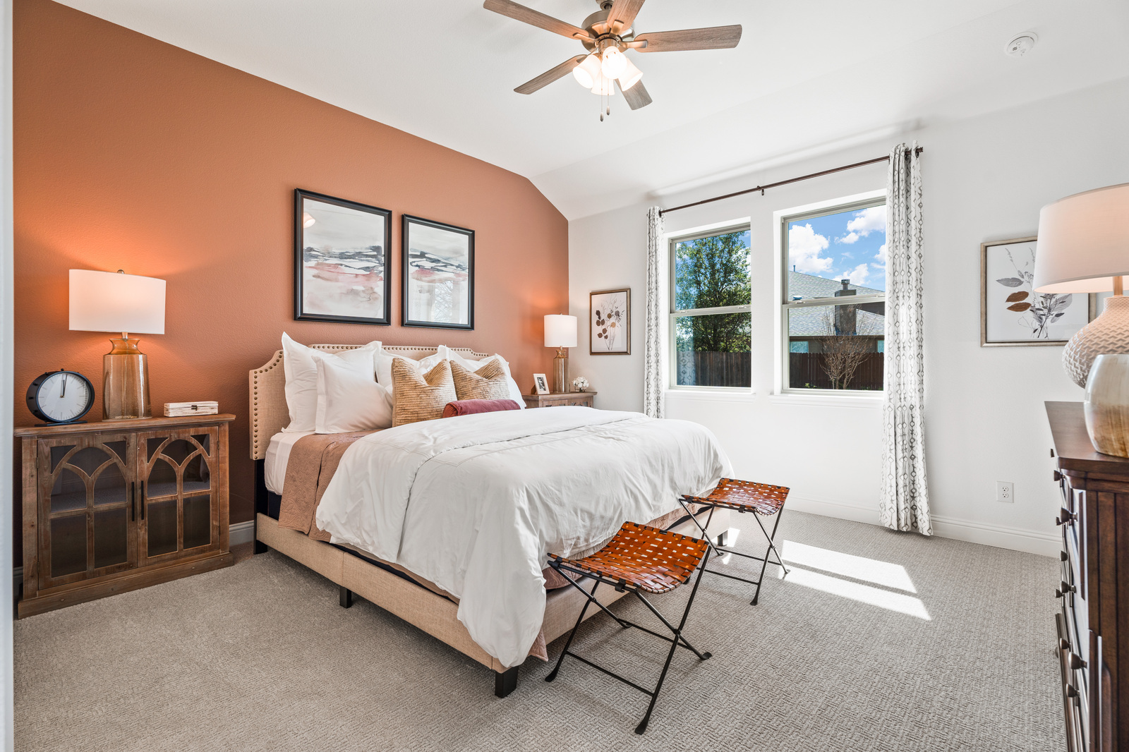 primary bedroom with orange accent wall