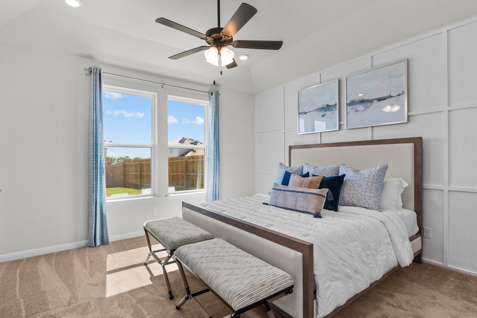 bedroom with white accent wall & carpet