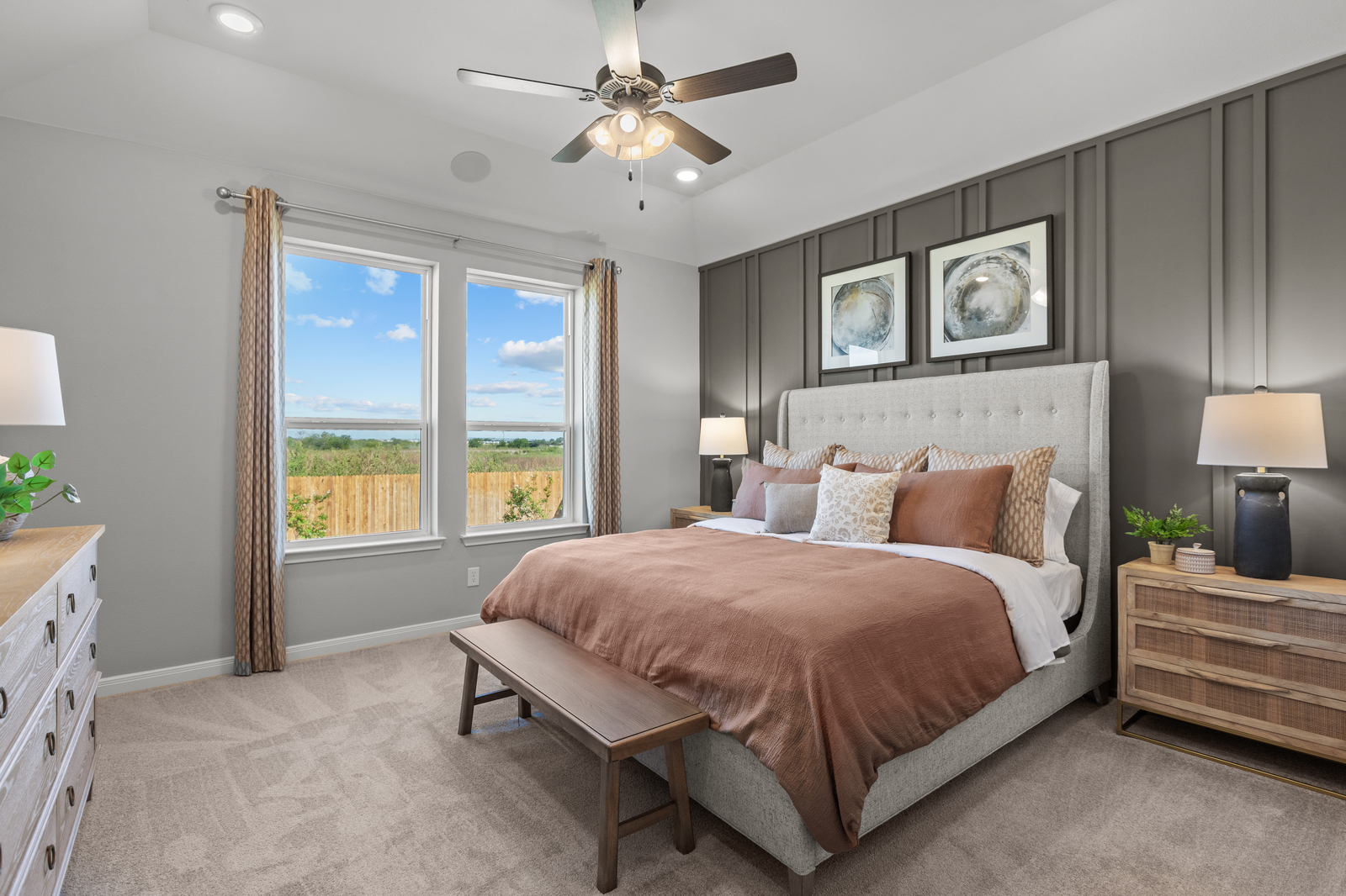 primary bedroom with carpet & brown accent wall