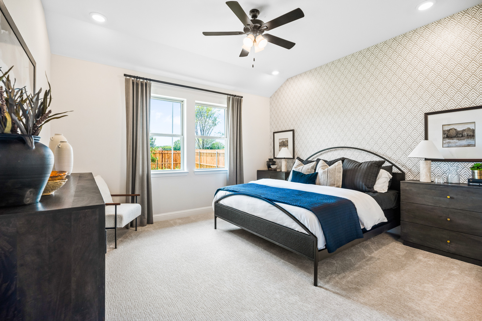 bedroom with large windows and carpet