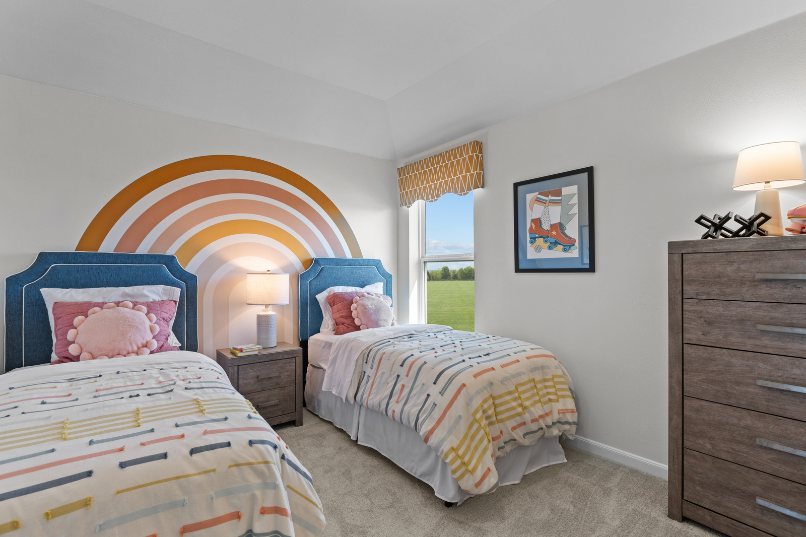 bedroom with two twin beds with pink & rainbow 