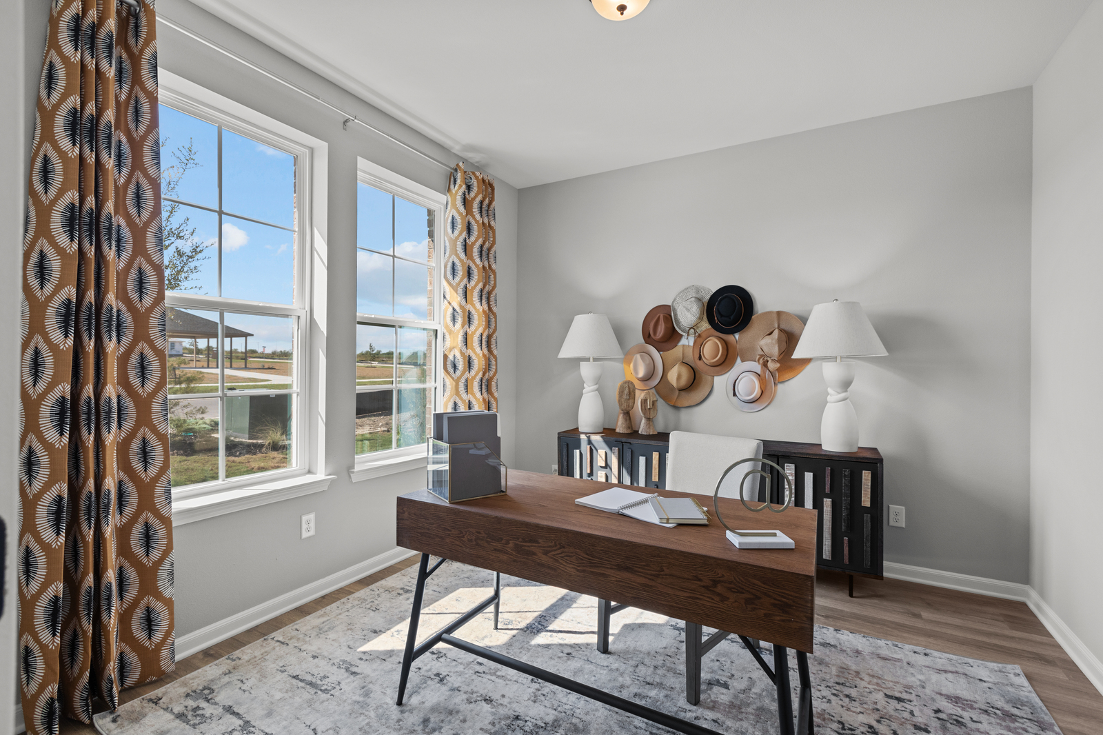 study with desk, window & wood flooring