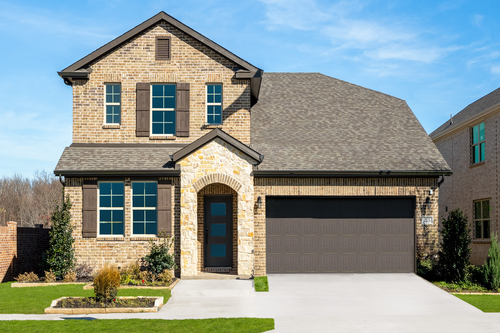 brick and stone exterior with shutters