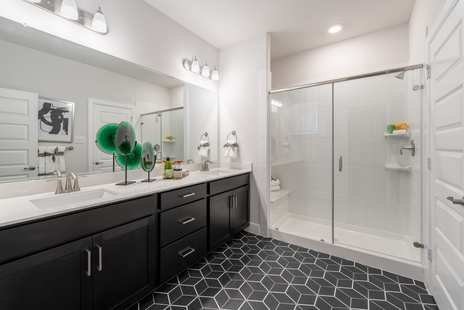 primary bathroom with black cabinets 