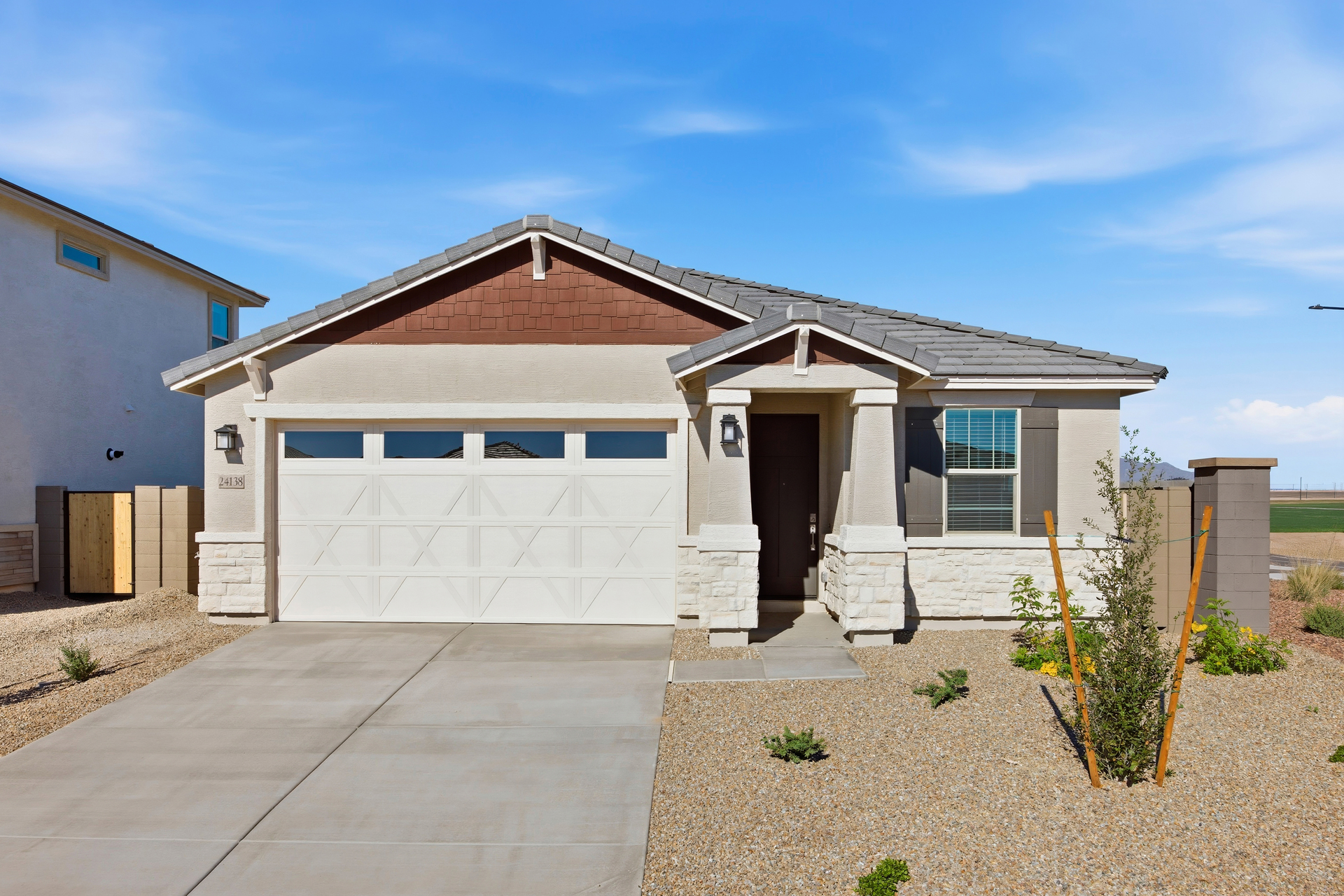 single-story single-family home with desert landscaping and desert driveway