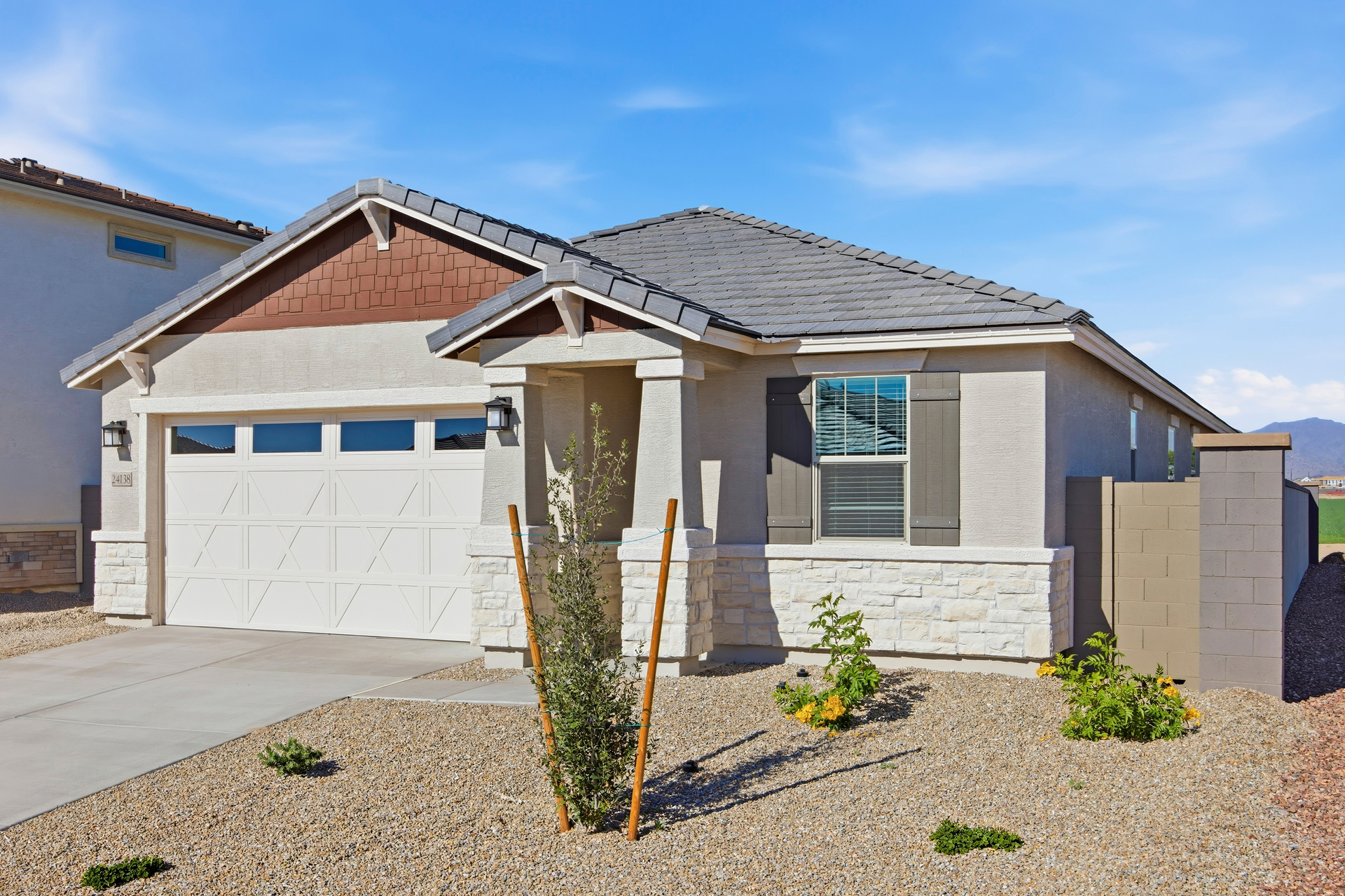 single-story home with desert landscaping and a concrete driveway