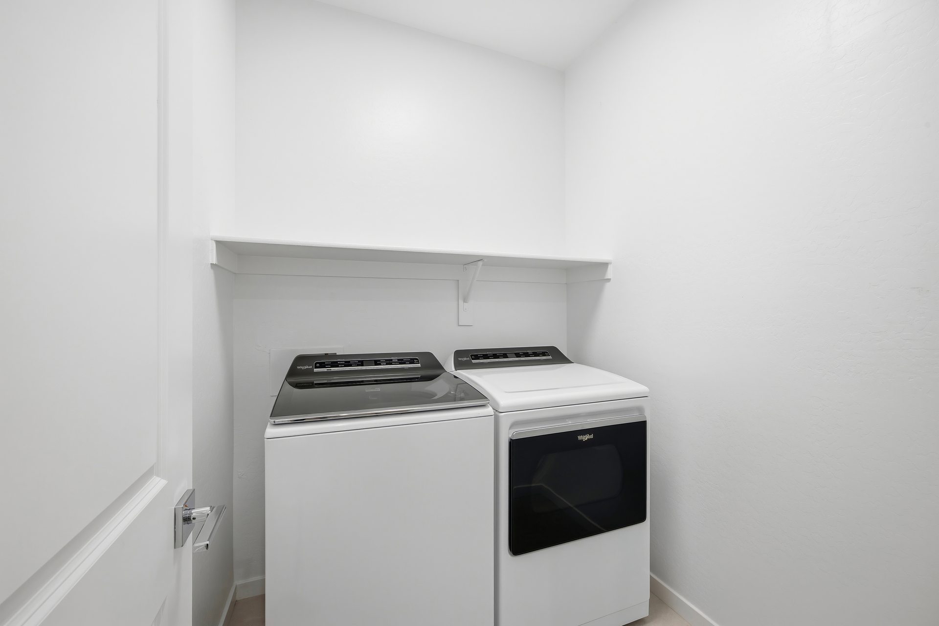 spacious bedroom with whirlpool washer and dryer