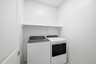 spacious bedroom with whirlpool washer and dryer