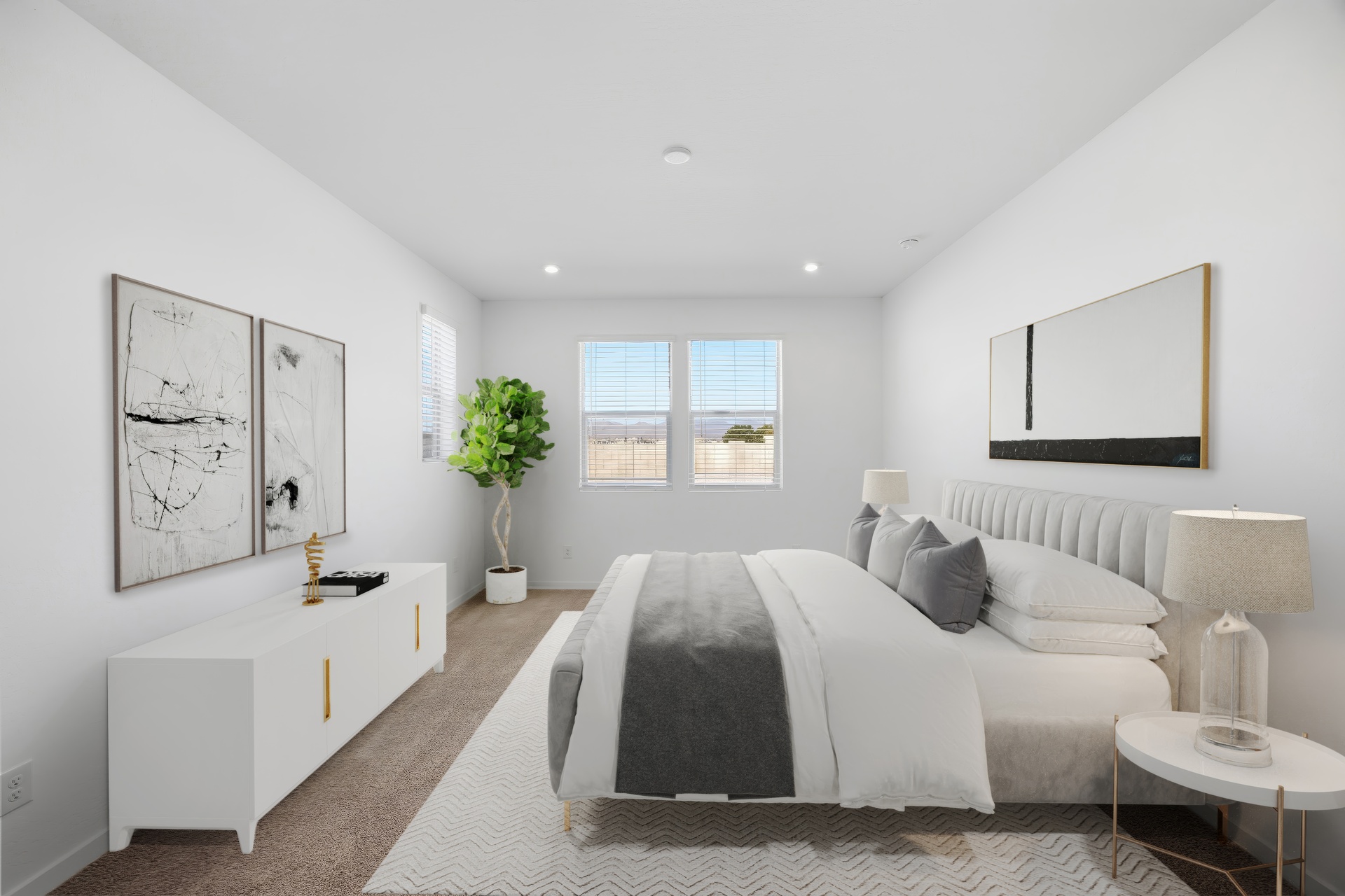spacious bedroom with a large white bed and white dresser