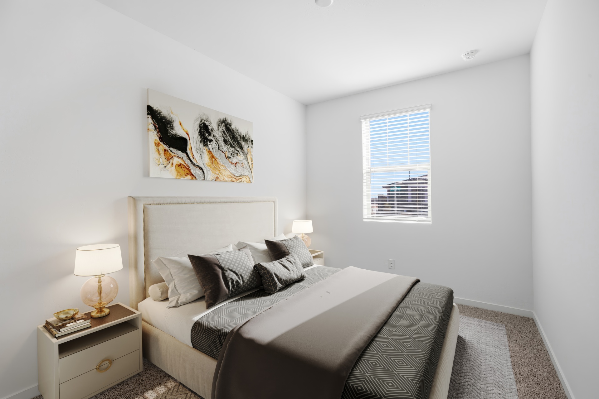 bedroom with a large bed with black bedsheets and artwork on the wall