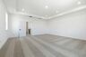 Bonus room with carpet, large windows, and tray ceiling