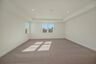 bonus room with carpet, large windows and tray ceiling