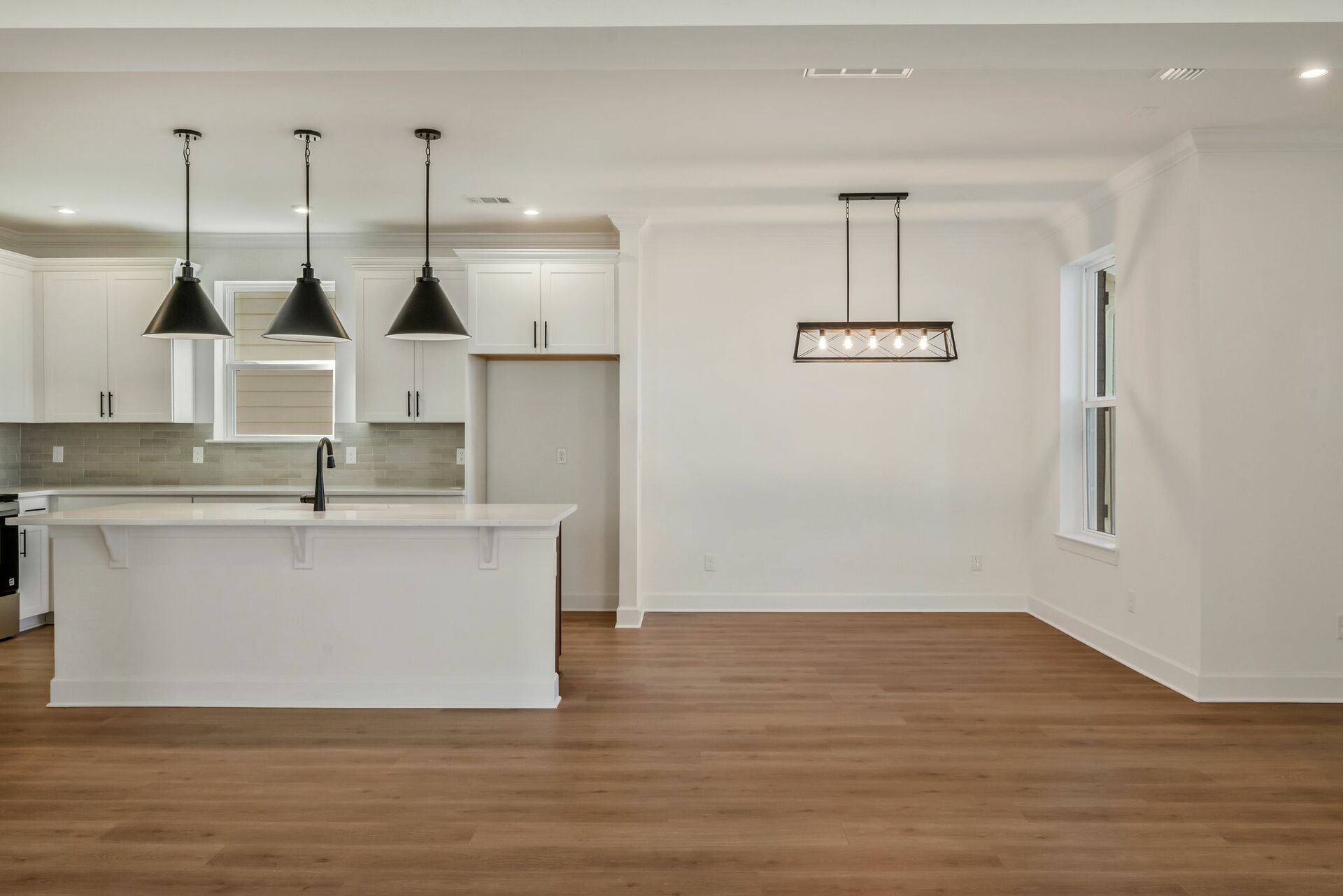 dining room with wood floors, windows, and a chandelier