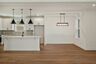 dining room with wood floors, windows, and a chandelier