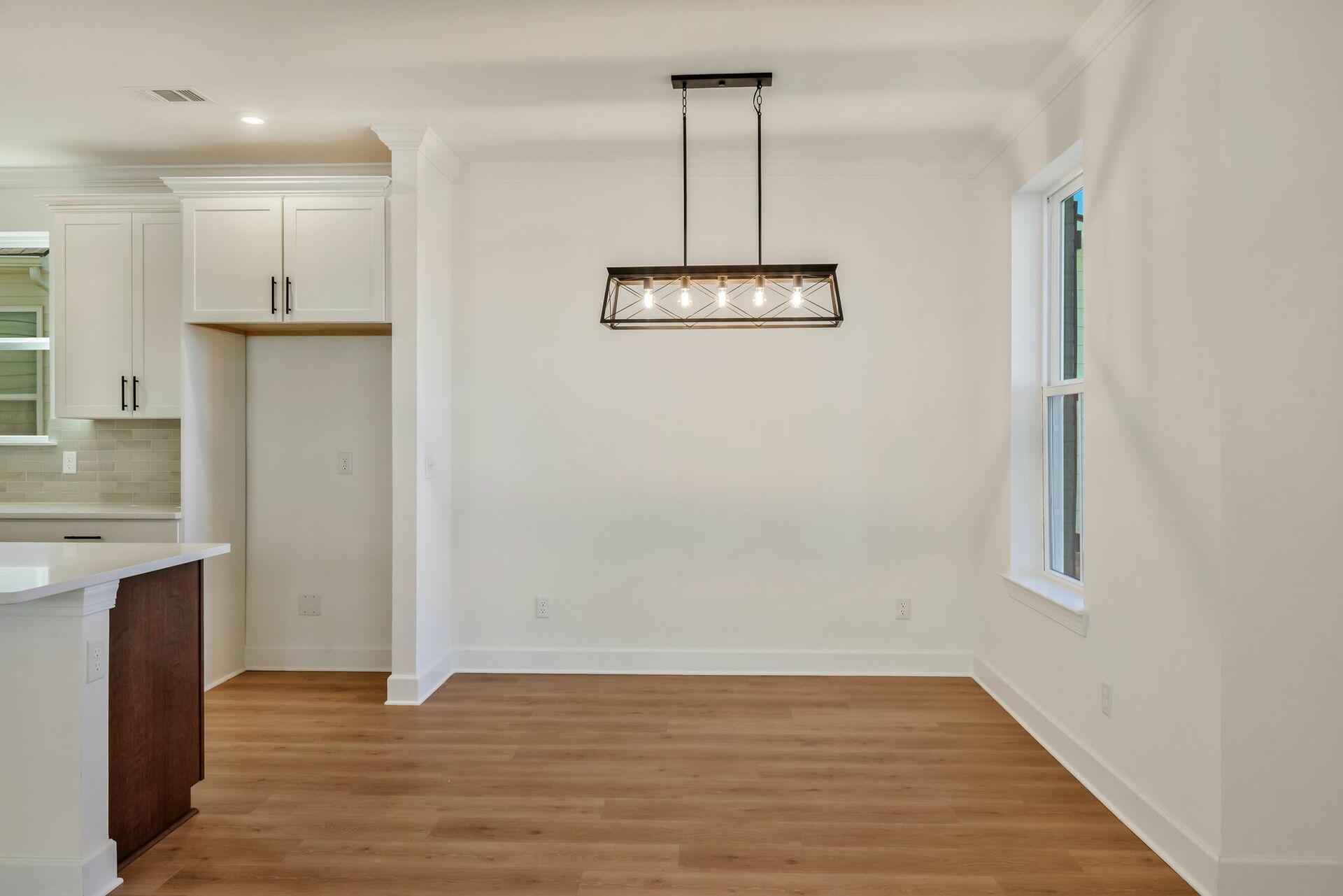 dining room with wood floors, windows, and a chandelier