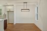 dining room with wood floors, windows, and a chandelier