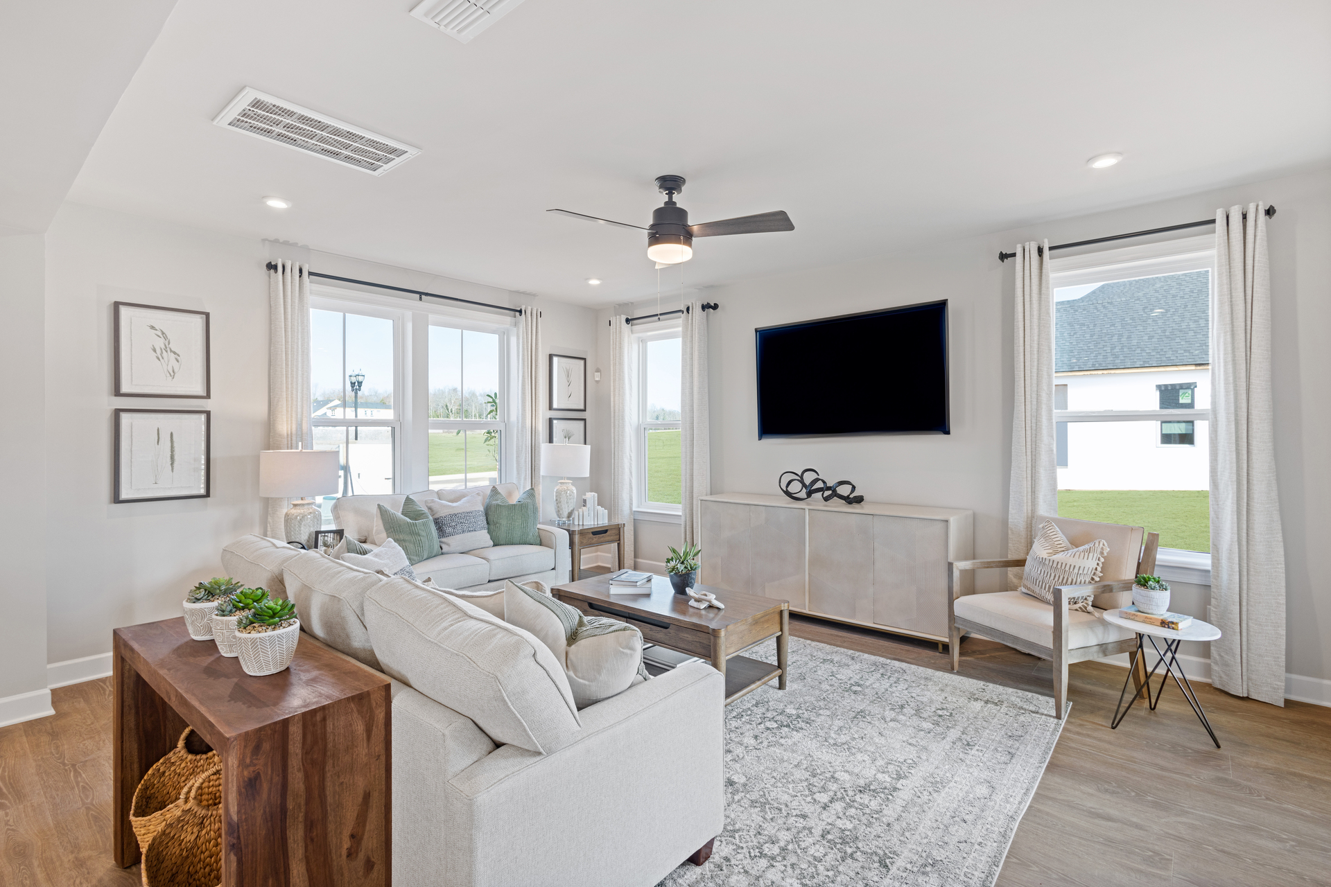 great room with large windows and white sofas