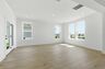 great room with wood flooring and large windows