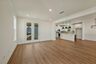 great room with wood floors, white walls and large windows