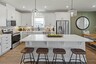 kitchen with white cabinets and green accent wall