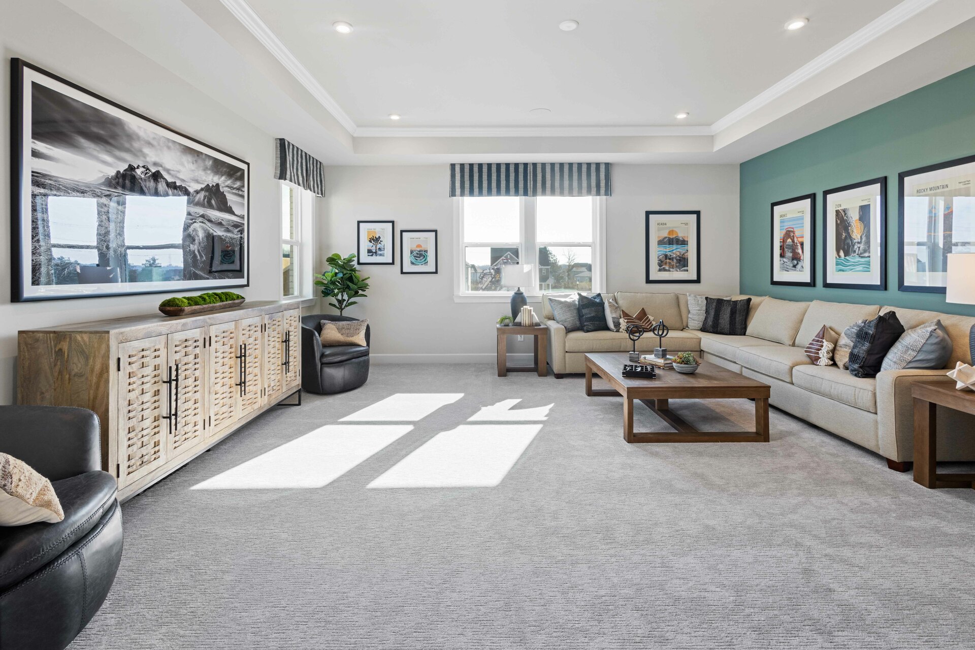 loft space with carpet flooring, large sofa, tv, large windows, and a tray ceiling