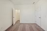 bedroom with carpet, windows, and walk in closet