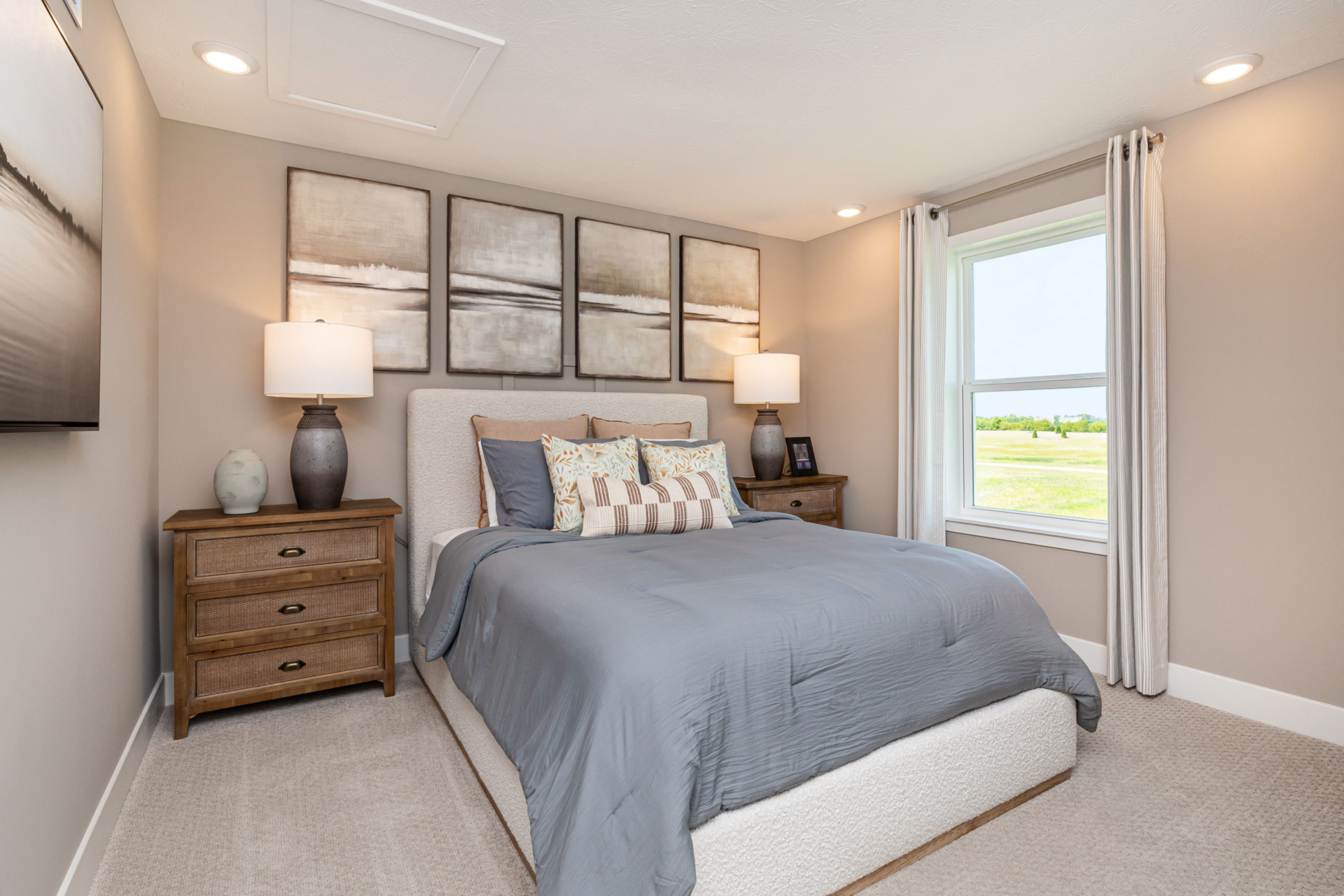 secondary bedroom with steel blue bedding and neutral decor
