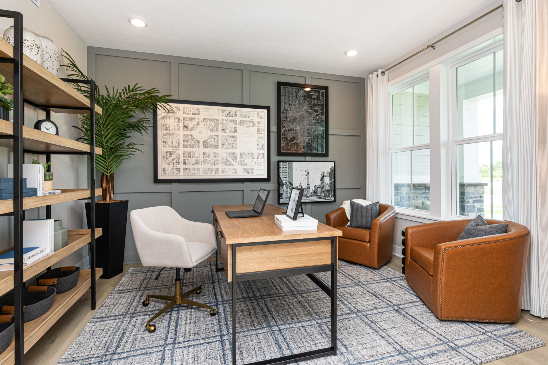 at-home office with leather barrel chairs and wooden display shelf