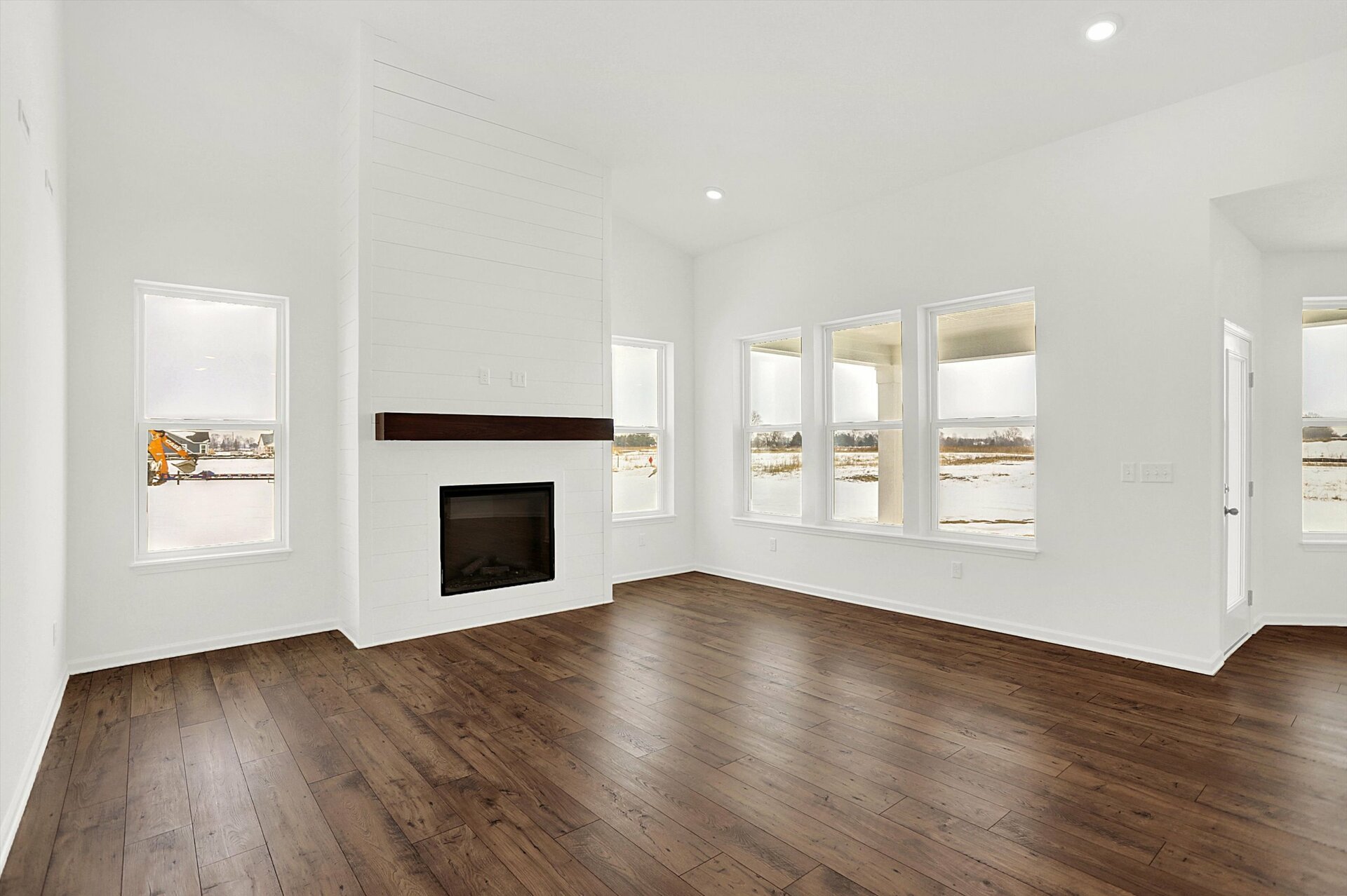 two-story great room with fireplace that has shiplap detail
