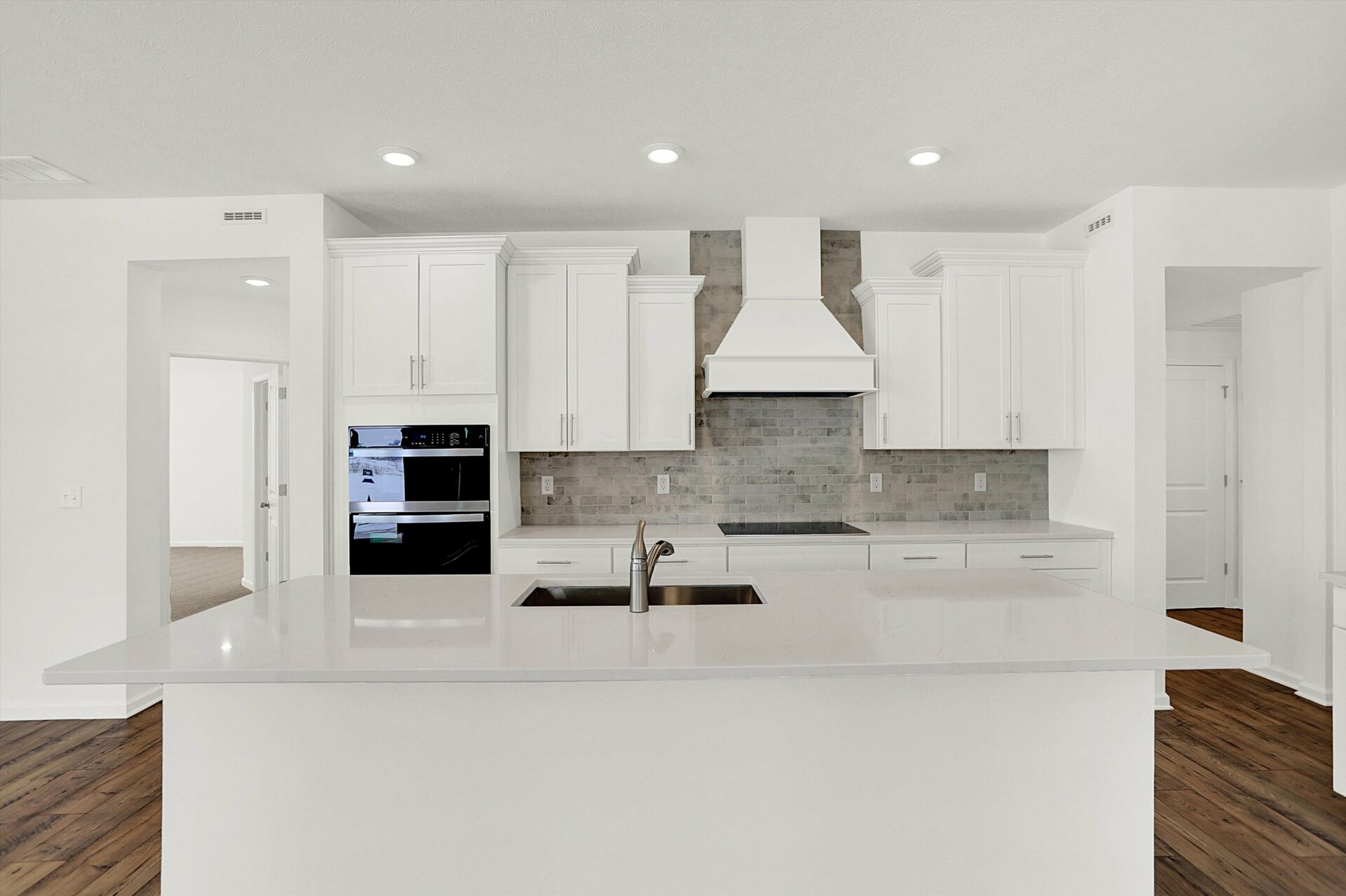 kitchen with white cabinets and gray tile backsplash