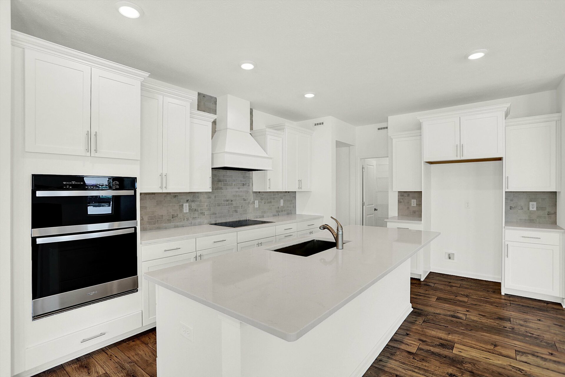 kitchen with white cabinets and gray tile backsplash
