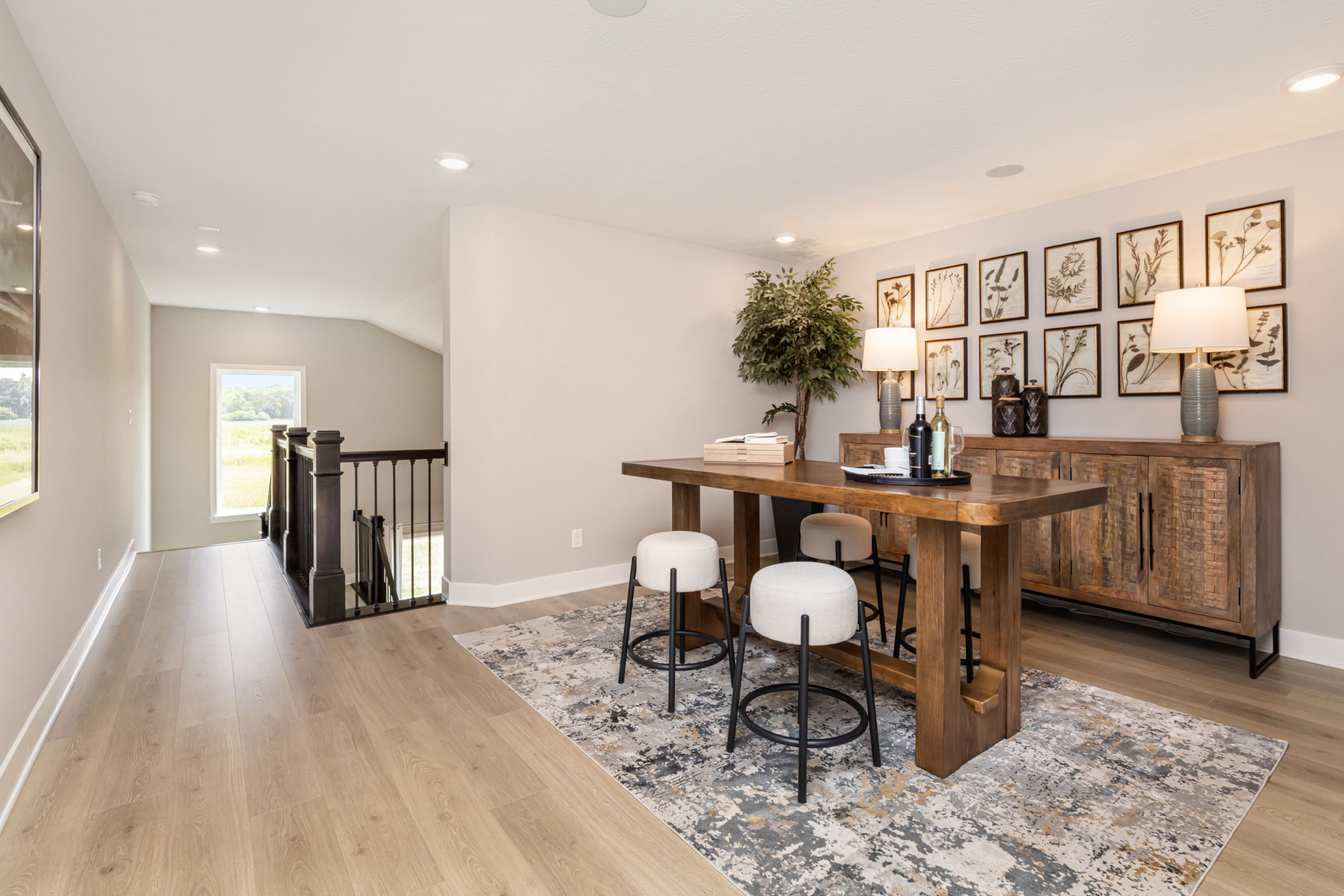 loft with wooden table, modern cushioned stools and abstract art