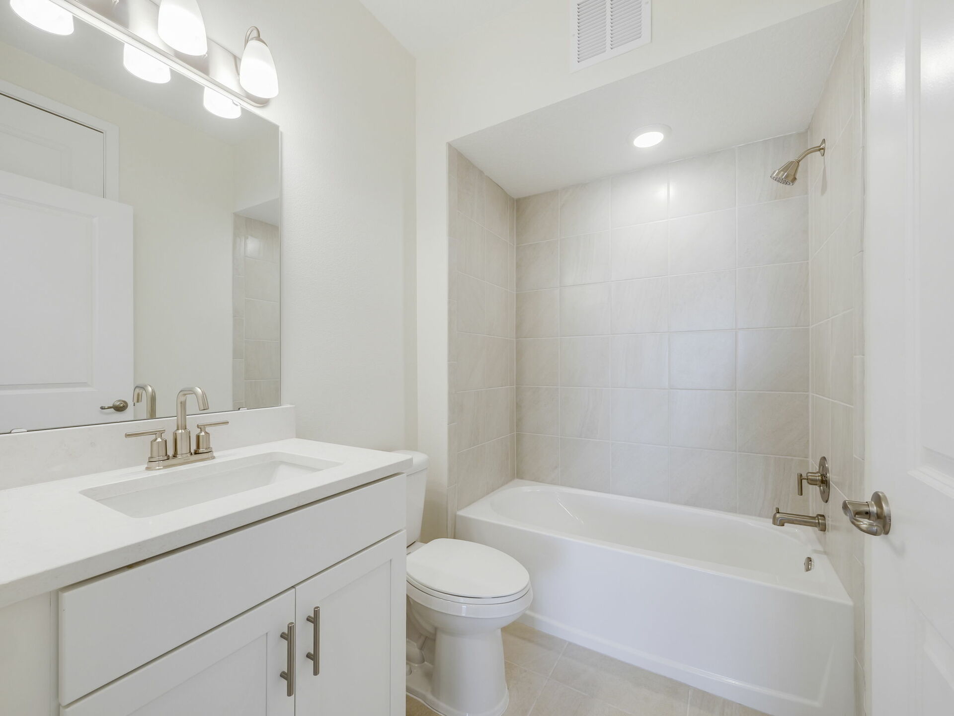 single sink vanity with water closet and shower
