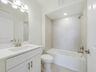 single sink vanity with water closet and shower