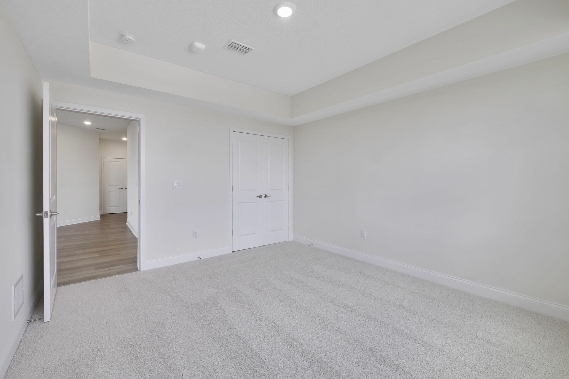 carpet throughout with tray ceilings