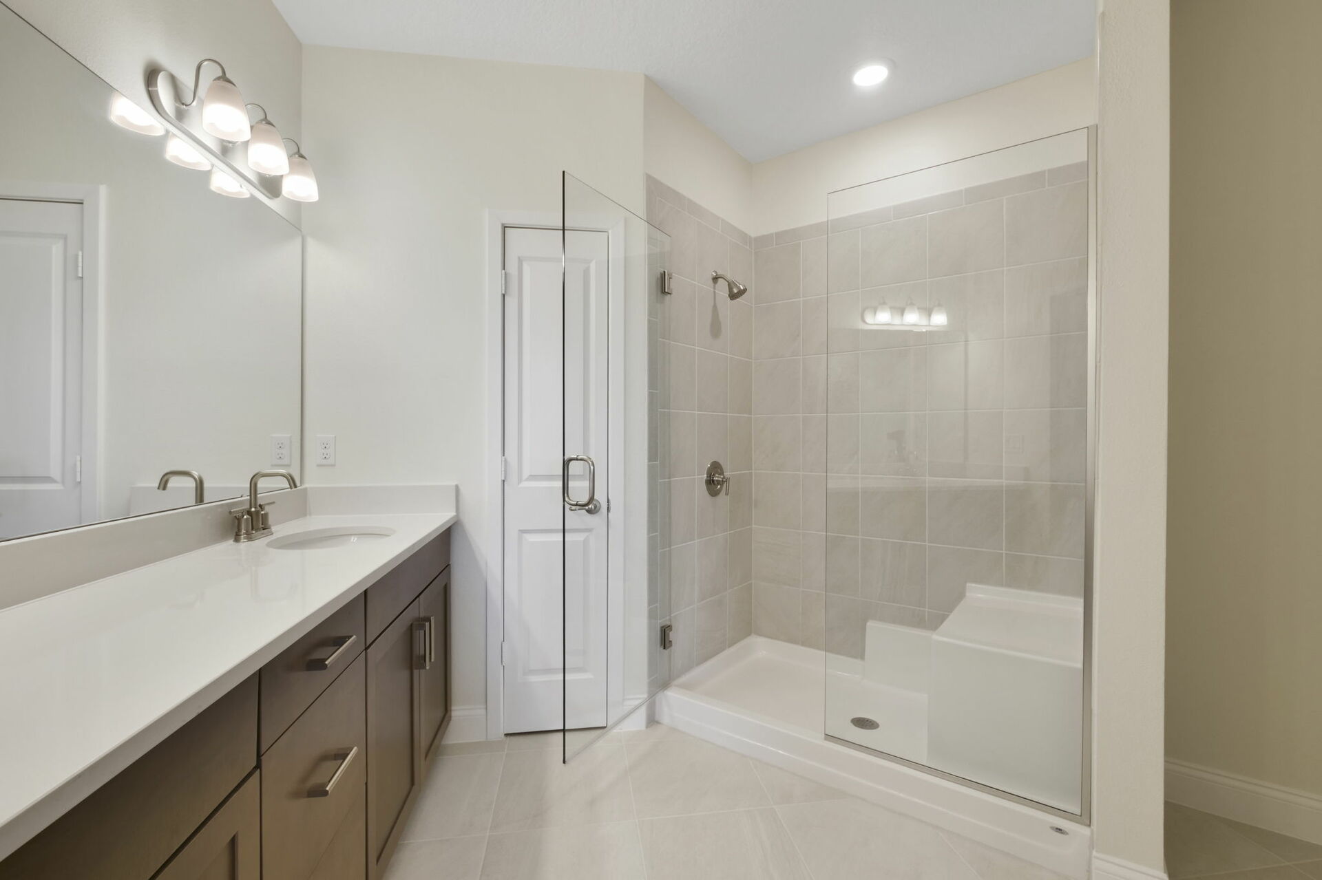 dual sink vanity with oversized shower with seating