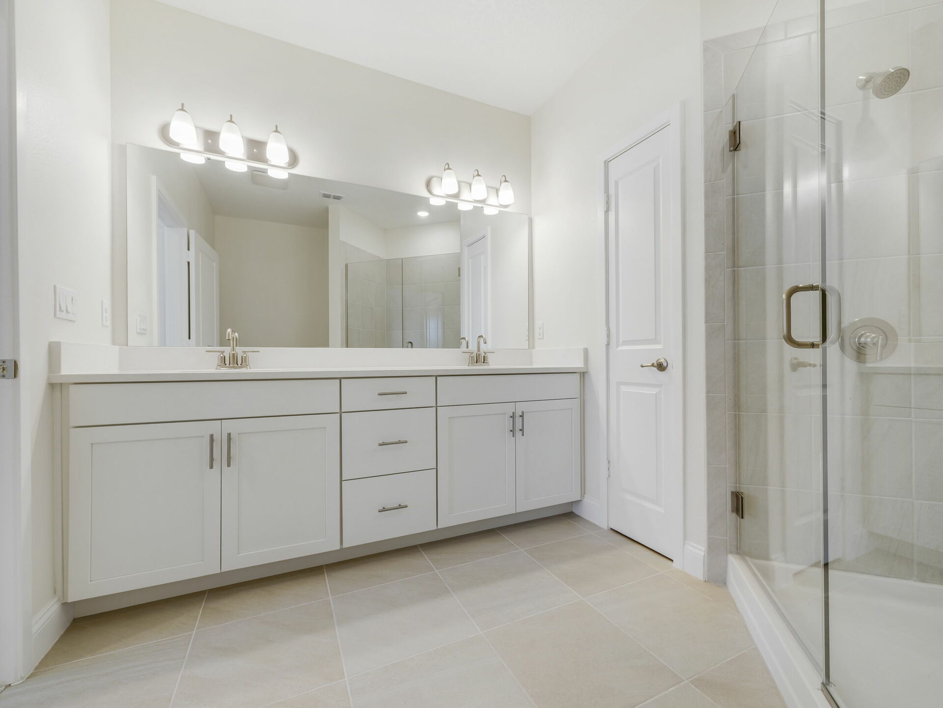 dual sink vanity, water closet, and semi-frameless shower