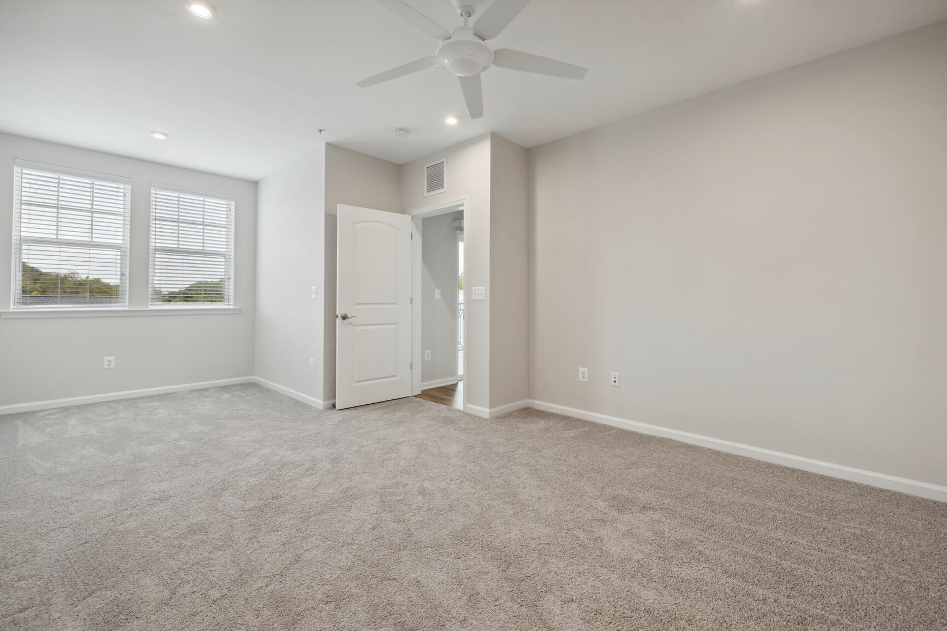 primary suite with carpet and white walls