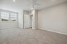 primary suite with carpet and white walls